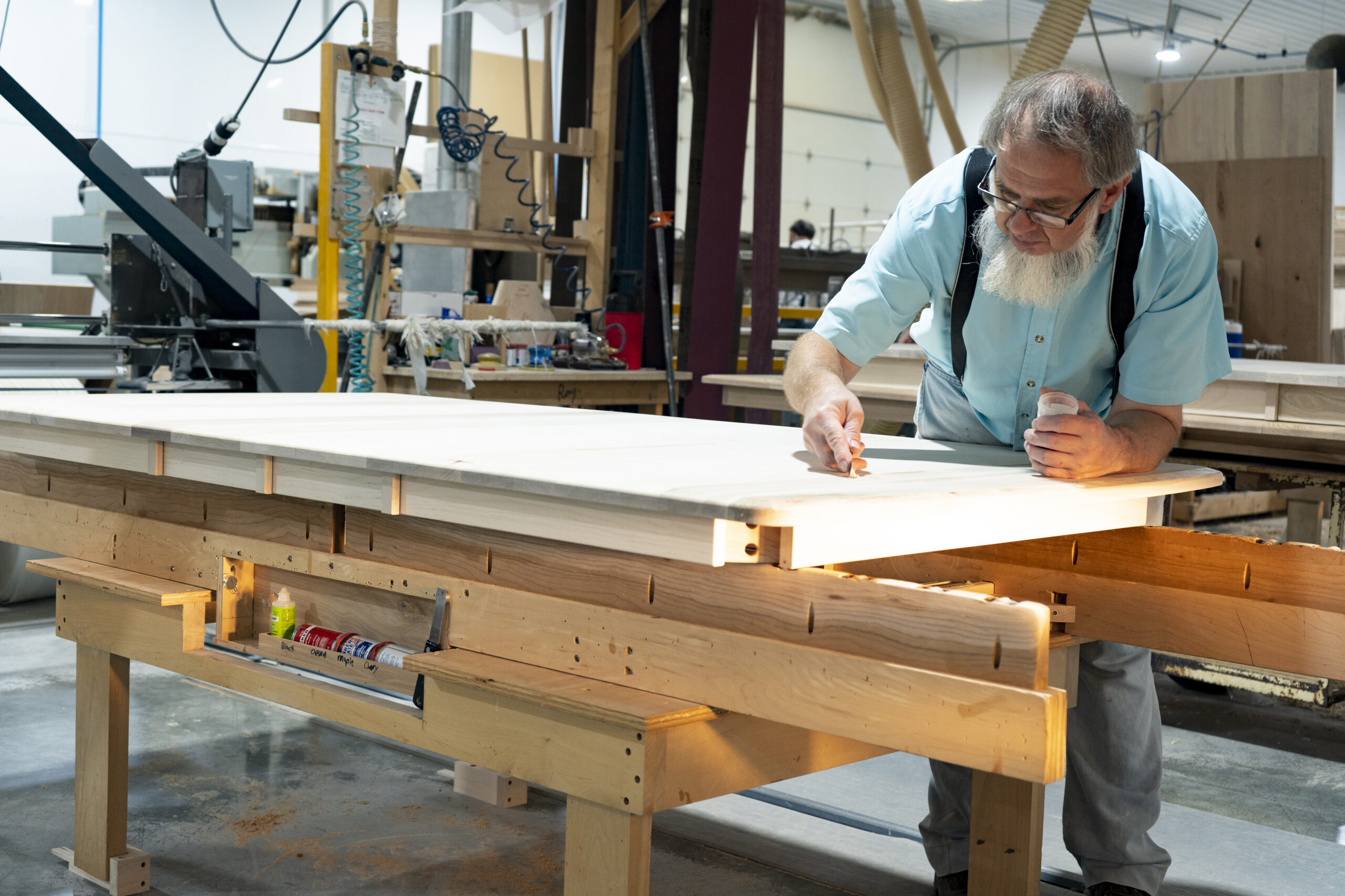 Amish woodworker crafting furniture in a workshop